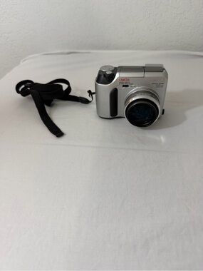 Olympus Silver Compact Digital Camera with Black Wrist Strap